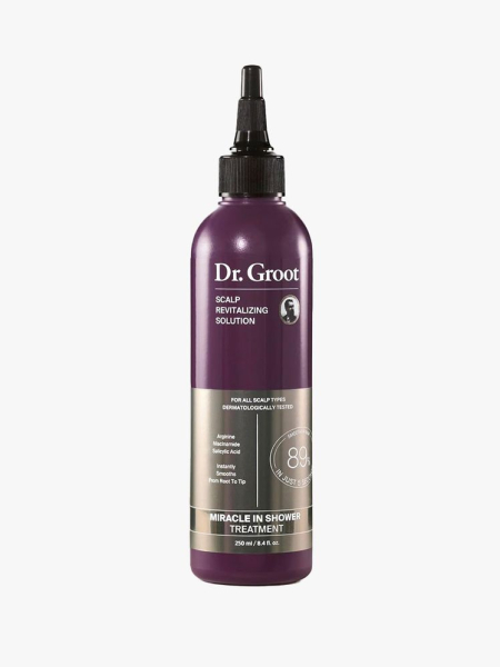 A bottle of Dr. Groot Scalp Revitalizing Solution Miracle In Shower Treatment with a nozzle top on a light gray background